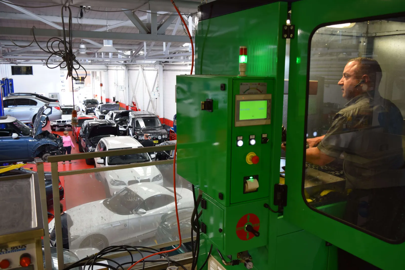 Technician operating the DPF cleaning machine in the workshop